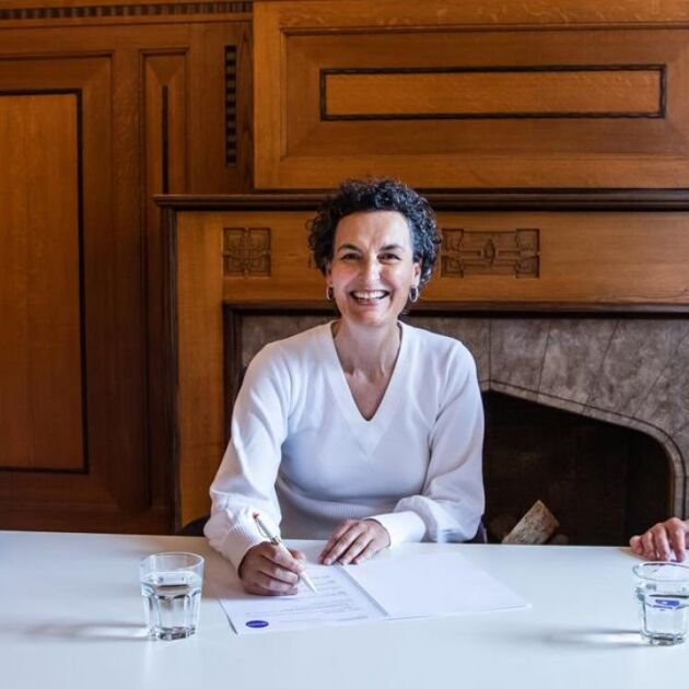 Elwin, man en vrouw tekenen contract, bes-cultuurlening op bonaire in een kantoor.