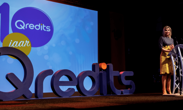 Podium met letters van Qredits erop.