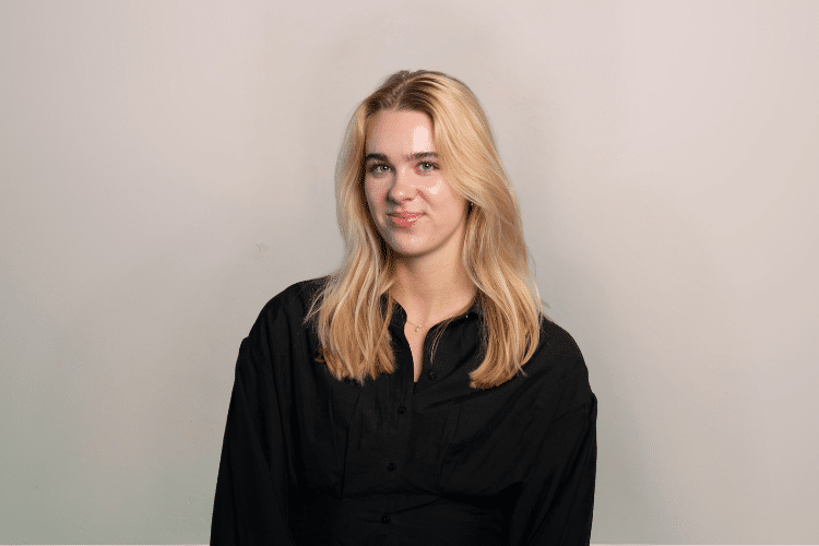medewerker-Qredits-vrouw-zwart-shirt-grijze-achtergrond